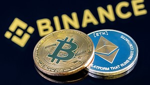 Bitcoin- und Ethereum-Münze liegen vor Binance-Logo